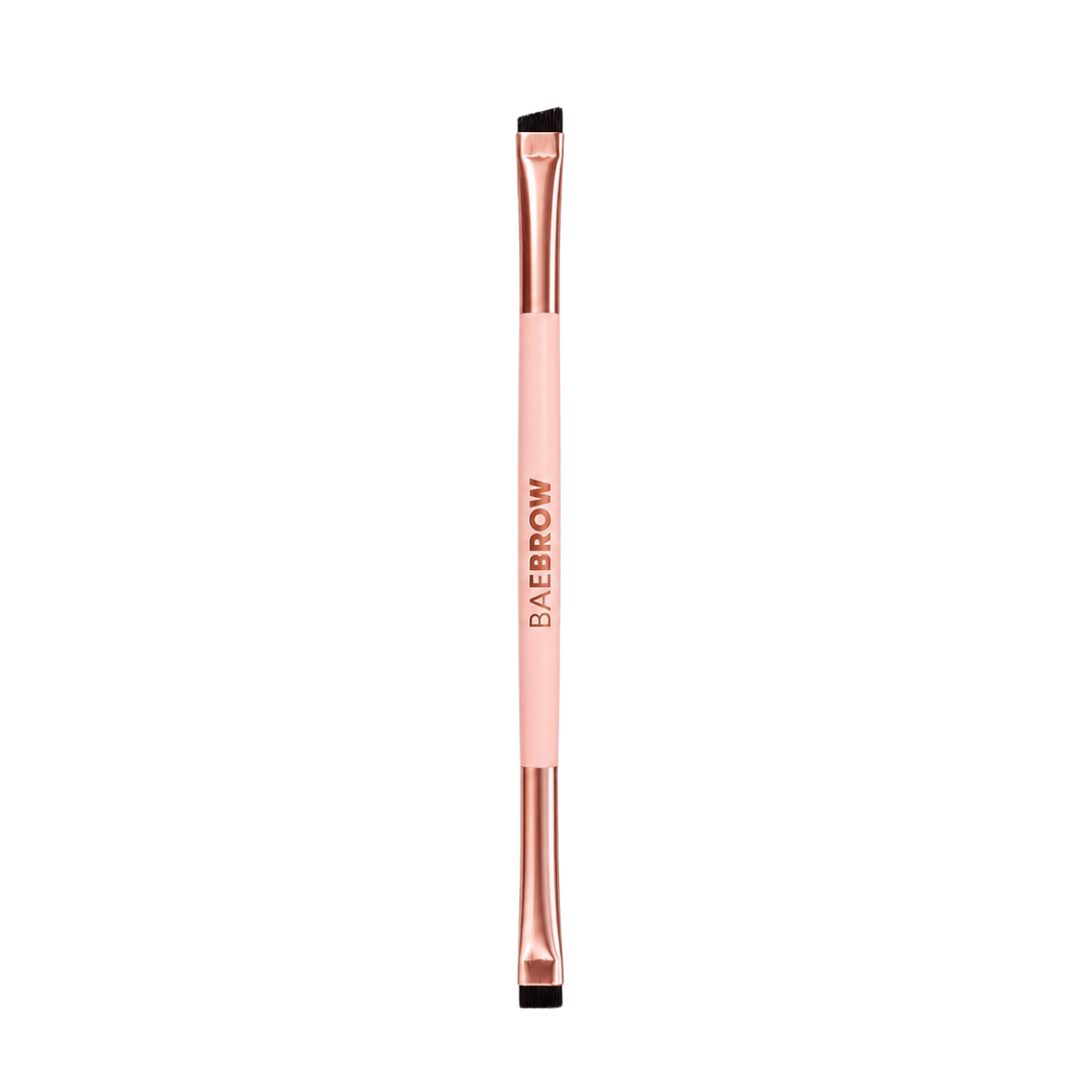Rose gold eyebrow styling brush with black bristle tip on a white background