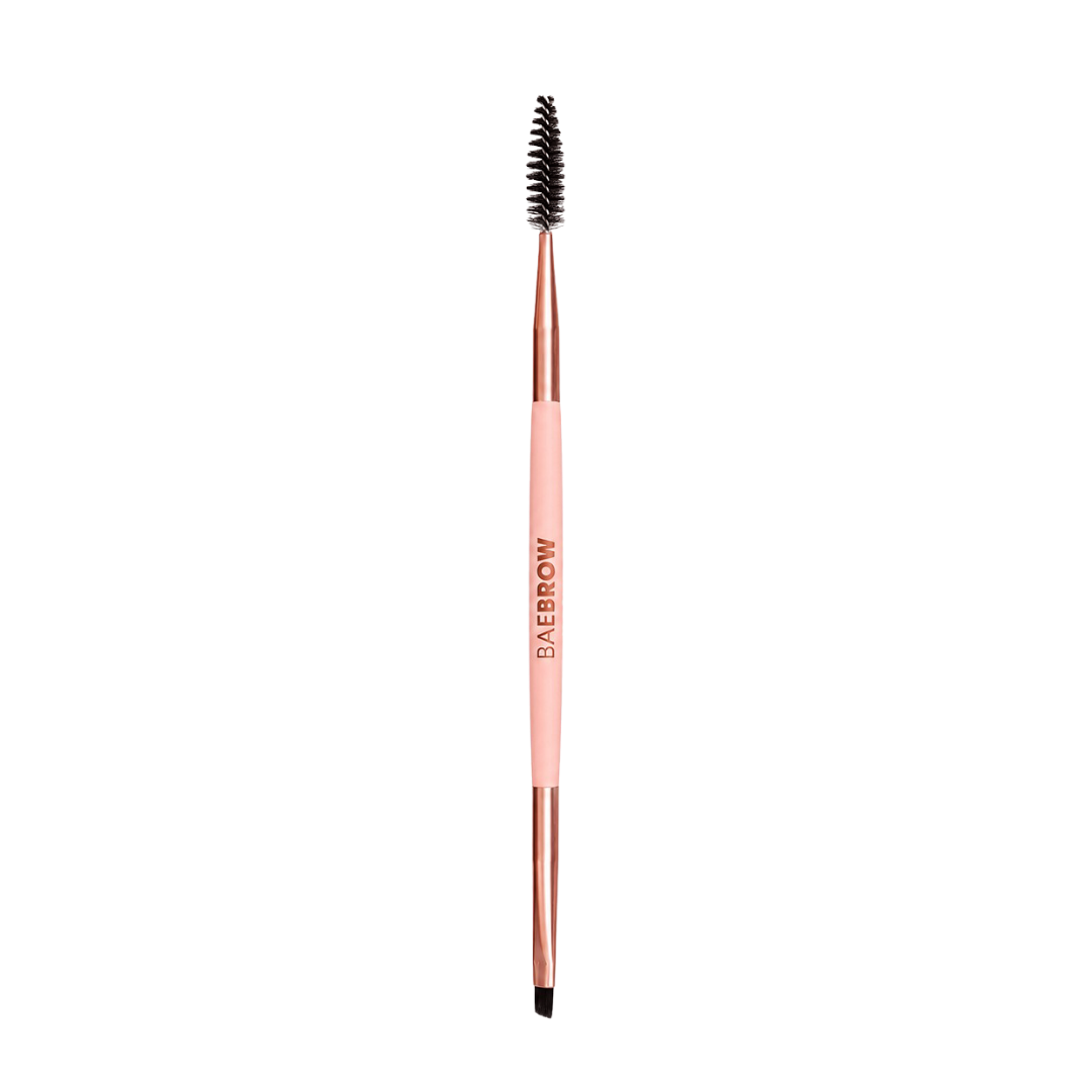 Eyebrow styling brush with rose gold handle and black bristle head on a white background