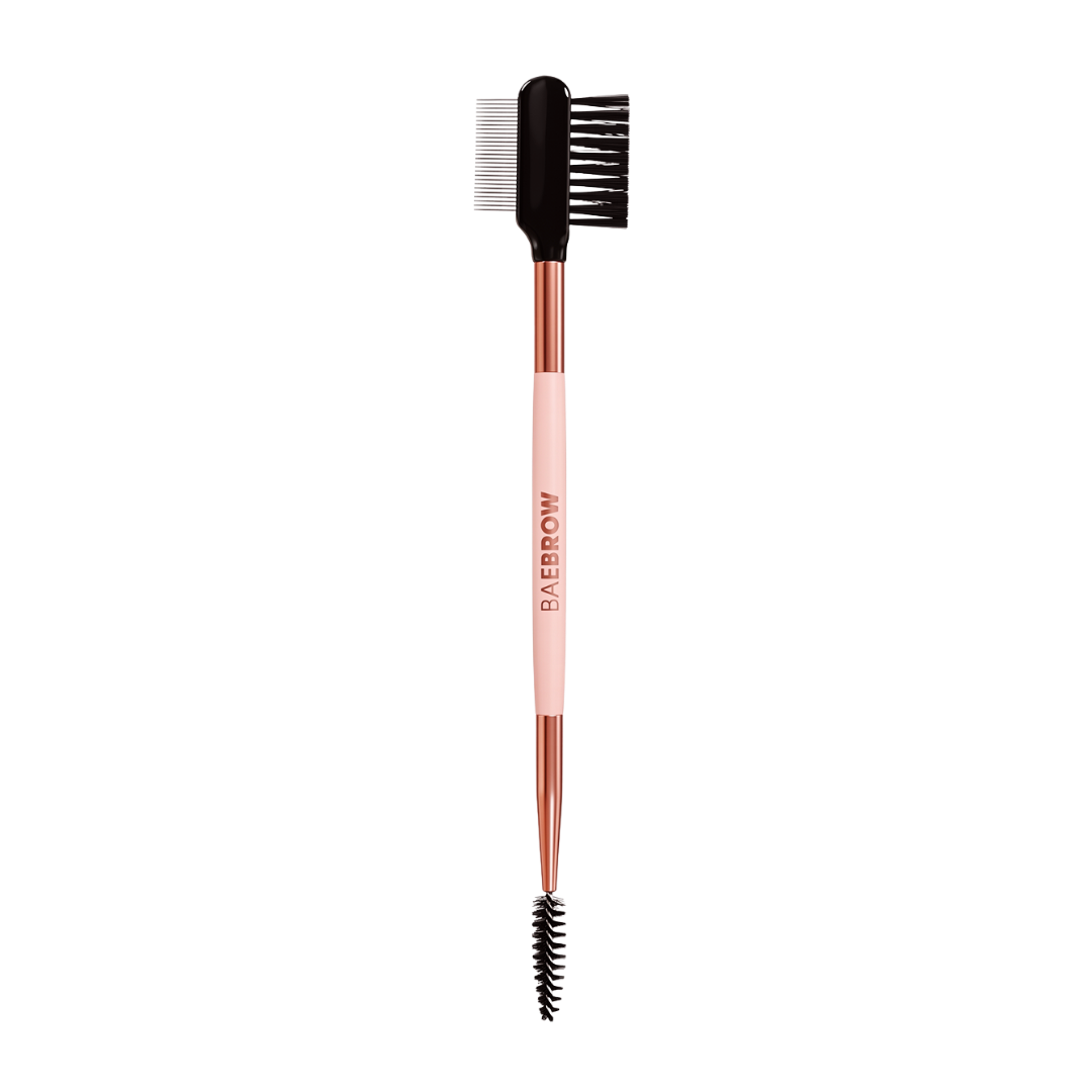 Eyebrow styling brush with rose gold handle and black bristles on a white background