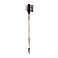Eyebrow styling brush with rose gold handle and black bristles on a white background