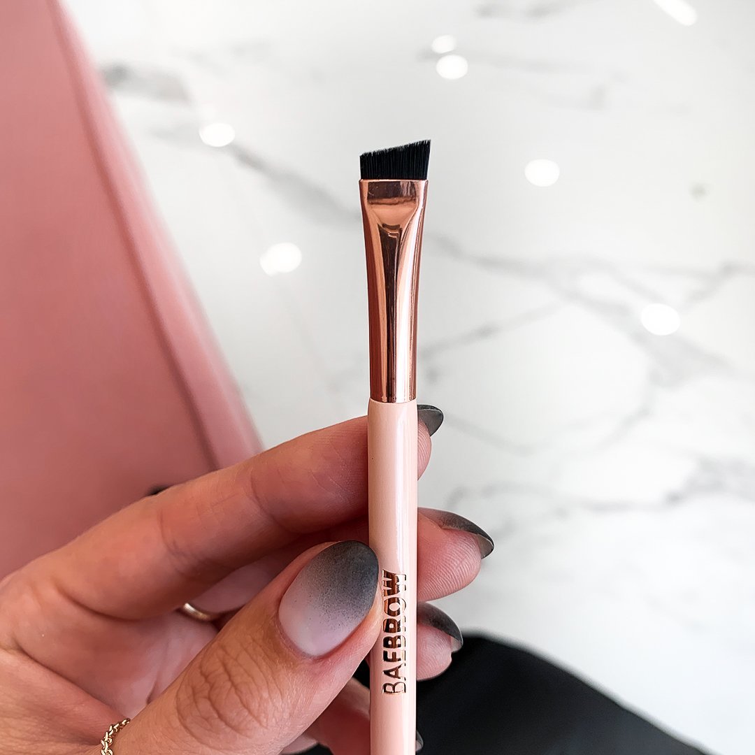 Dual Ended Brow Line Brush (Brush #2) -  for blending product and make the eyebrows look more natural with angled shape and tight synthetic bristles in light pink color 